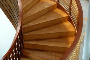 Beautiful Wooden spiral staircase inside the building photo