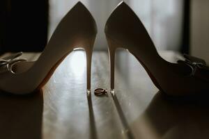 wedding ring white shoes of the bride in soft light photo