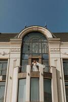 bride with a veil on the hotel balcony in a wedding dress, copy space, free space photo