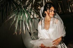 Portrait of the bride with studio light in her room. great hair and makeup. morning of the bride. preparation for the wedding ceremony photo