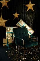 Golden stars hanging on a dark background, New Year's gifts in gold wrappers, a green chair on a dark background photo