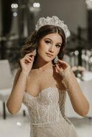 glamorous studio photo of a girl with long brown hair in a wedding dress. Luxurious interior. Vertical photo.