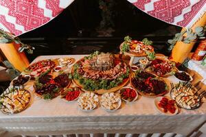 Cossack table in the best restaurants. Festive table at the wedding. National Ukrainian cuisine. Fat, sausages, alcohol. Catering. photo