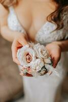 Beautiful bride in wedding dress sitting on bed in her bedroom. Nice waist. Classic interior photo