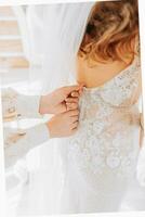 girlfriends help the bride prepare for the wedding. photo