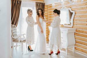 girlfriends help the bride prepare for the wedding. photo