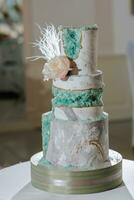 decorated wedding cake, in three tiers, decorated with flowers photo