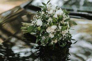 wedding bouquet in green style from different flowers on a black background photo