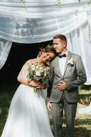 Beautiful wedding couple at a summer wedding ceremony. Wedding vows, emotions and tears photo