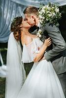 Beautiful wedding couple at a summer wedding ceremony. Wedding vows, emotions and tears photo