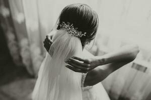 classic bridal hairstyle from behind, close-up, veil secured with handmade tiara. photo