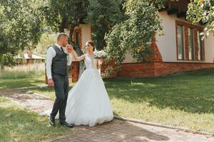 The bride and groom walk after the wedding ceremony. Young couple walking in the garden. photo in nature, forest, in nature.