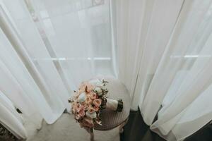 wedding bouquet of roses and various flowers on a chair in the wedding room photo