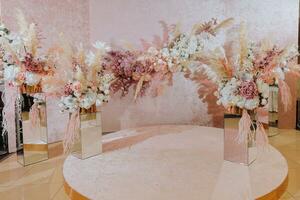 Decor at the wedding. Everything is almost ready for the wedding celebration. A wedding banquet, many flowers, golden colors, a rich and refined wedding photo