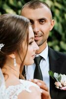 Young wedding couple enjoying romantic moments outdoors in autumn park under sunlight photo