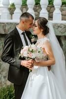 Young wedding couple enjoying romantic moments outdoors in autumn park under sunlight photo