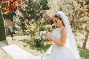 Happy stylish bride with wedding bouquet enjoying the best day of her life photo