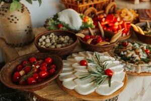 Snacks at the wedding, cheese, sausage, vegetables, meat products, Cossack table at the Ukrainian wedding. photo