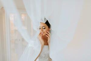 Beautiful bride. portrait. wedding makeup hairstyle, gorgeous young woman in white dress at home. series photo