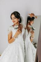 the bride holds a boutonniere in her hands. wedding flowers A luxurious woman is enjoying her day. Luxury wedding dress. Professional makeup photo