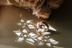 Gold wedding rings in sunlight, beautiful highlights on gold wedding rings photo