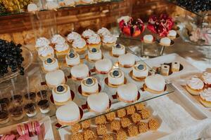 un delicioso boda. caramelo bar con varios bombones celebracion concepto. de moda postres mesa con dulces, dulces. foto