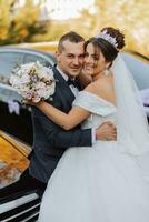 retrato de contento Boda pareja, novia y novio en otoño bosque, parque posando cerca Roca escaleras. un hombre en un traje, un niña en un Boda vestido. novio Besos su novia. foto desde encima