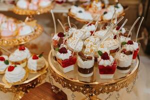 A delicious wedding. Candy bar with various chocolates. Fruit table. Celebration concept. Fashionable desserts. Table with sweets, candies. photo