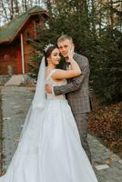 Portrait of the bride and groom in nature, a beautiful couple in love. Autumn tree leaves. The newlyweds are walking in the autumn park photo