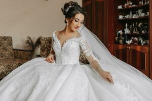 portrait of the bride in her wedding dress in her room. Morning of the bride. Preparation for the wedding ceremony photo