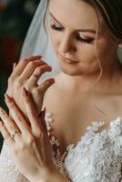 portrait of the bride in her wedding dress in her room. Morning of the bride. Preparation for the wedding ceremony photo