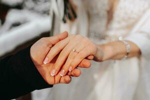 She said yes, concept of an expensive gold diamond ring on a woman's hand, held by her fiance. Man holding woman's hand with ring close-up, women's jewelry shot idea photo. photo