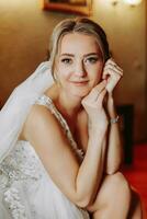 Portrait of a tender beautiful bride wearing a fashionable wedding dress. Perfect makeup and hair photo