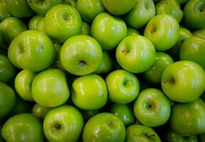 Green apples on the counter of the store. Close-up. photo