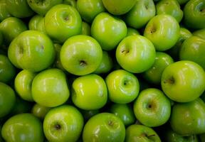 Green apples on the counter of the store. Close-up. photo