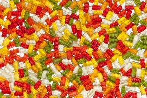 Colorful gummy candies on white background. Top view. photo