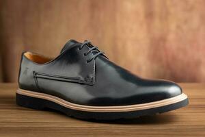 Men's black shoes on a wooden background. Shallow depth of field. photo