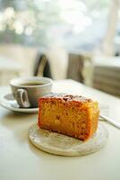 Cup of coffee and cake on table in cafe, stock photo