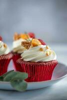 Cupcakes with cherry on a red napkin on a white background photo