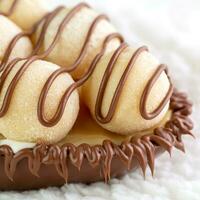 Chocolate candies in chocolate glaze on white background, closeup photo