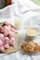 Breakfast in bed with coffee, croissant and peonies photo