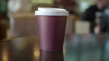 Craft disposable coffee cup on cafe table video