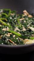 Top view of bowl with cooked spinach on table video