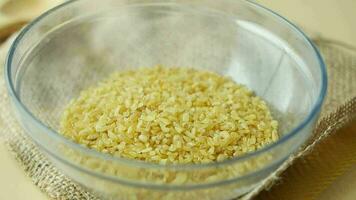 slow motion of pouring Raw Bulgur Rice in a bowl video