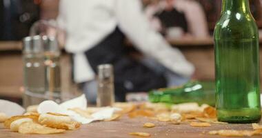 Potato chips on a dirty table in a small restaurant. Staff in the background of a messy table. video