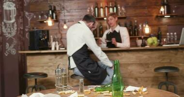 restaurante personal descuidar su deberes después restaurante es cerrado. irresponsable restaurante personal chateando a el bar mostrador mientras ellos tener a limpiar un sucio mesa. video