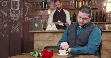 Angry man tired of waiting for his girlfriend and leaves the restaurant. Man cant wait anymore, leaves the flowers behind him and leaves the restaurant. video