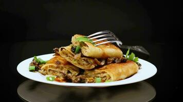 fried thin pancakes stuffed with meat and mushrooms. video