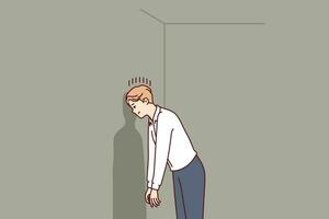 Depressed man in hopeless situation is banging head against wall trying to come up with solution vector