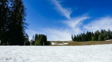 snow and blue sky during hiking in the mountains and spring photo